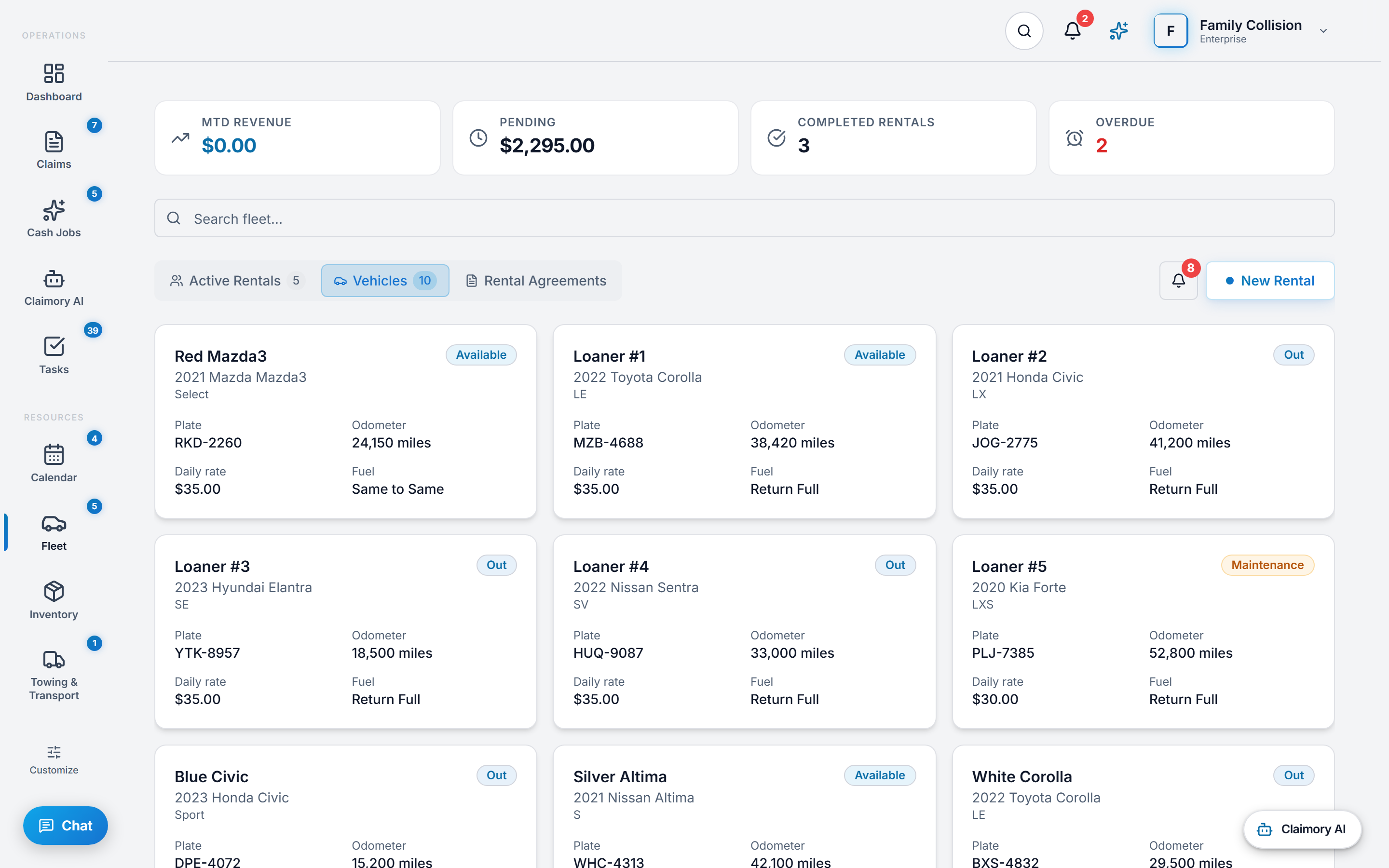 The Vehicles tab of the fleet management screen in Claimory, listing the loaner cars as cards, each with a nickname, the year, make, model and trim, a status badge reading Available, Out or Maintenance, the plate, the odometer mileage, the daily rate and the fuel policy.