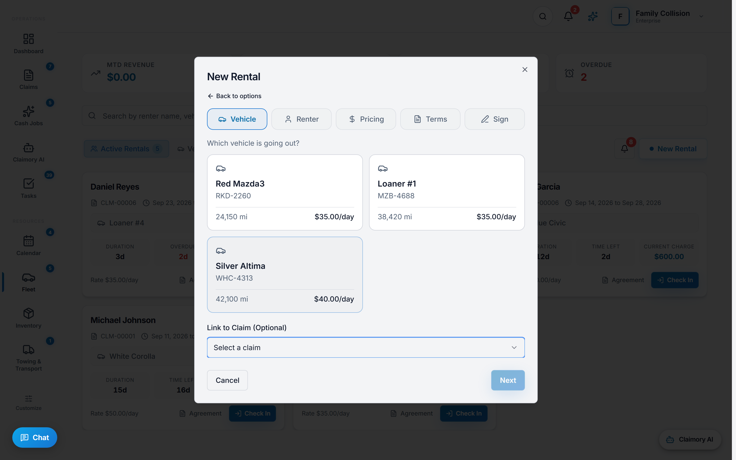 The New Rental dialog in Claimory on its Vehicle step, with Vehicle, Renter, Pricing, Terms and Sign steps across the top, asking which vehicle is going out and offering three loaner cars with their plate, mileage and daily rate, an optional link to a claim, and Cancel and Next buttons.